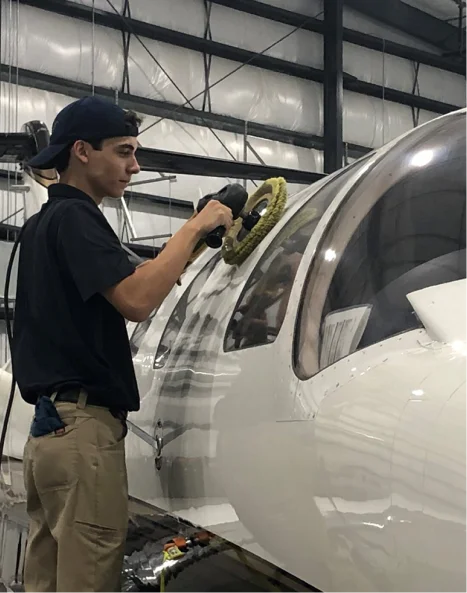 Professional aircraft detailing technician washing aircraft exterior with water in Phoenix Arizona
